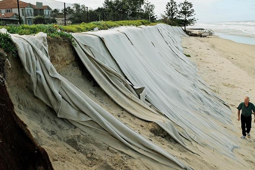 This photo taken on April 26, 2012 shows felt sheeting draped over sandhills to help slow the progress of erosion in front of the Meridien holiday apartments at Old Bar Beach in the coastal town of Old Bar in Australia's New South Wales state.&nbsp;R