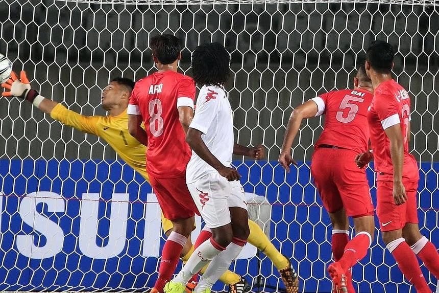Singapore's goalkeeper Hassan Sunny (in yellow) saves a shot on goal from Oman during the 17th Asian Games Incheon 2014 football group stage held at the Hwaseong Sports Complex Main Stadium on Sep 17, 2014. -- ST PHOTO: NEO XIAOBIN