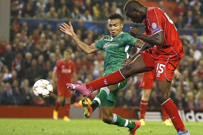 Liverpool's Mario Balotelli (right) scores a goal against Ludogorets during their Champions League soccer match at Anfield in Liverpool, northern England on Sept 16, 2014. -- PHOTO: REUTERS