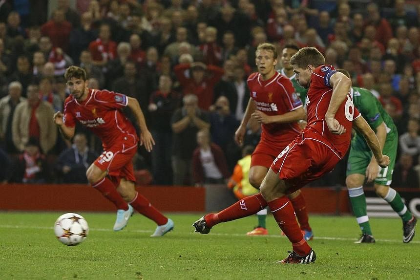 Liverpool's Steven Gerrard (right) scores a penalty against Ludogorets during their Champions League soccer match at Anfield in Liverpool, northern England on Sept 16, 2014. -- PHOTO: REUTERS