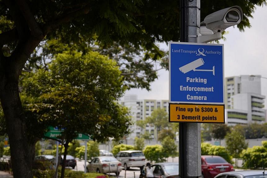 A sign warns about the penalty for parking on a double yellow line in Jurong Gateway in April 2014 in an area monitored by a Land Transport Authority closed-circuit television (CCTV) camera. From Sept 22, 10 more locations on Singapore roads will be 