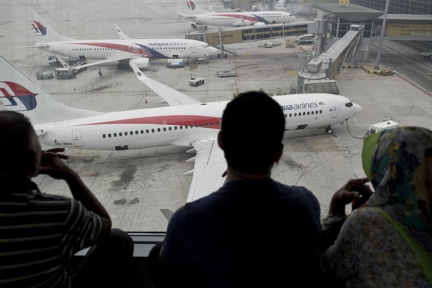 Malaysia Airlines (MAS) has condemned an Internet news report and the author of a book for publishing stories relating to flights MH131 and the ill-fated MH370, labelling them "amateurish" and "fraudulent" respectively. -- PHOTO: AFP