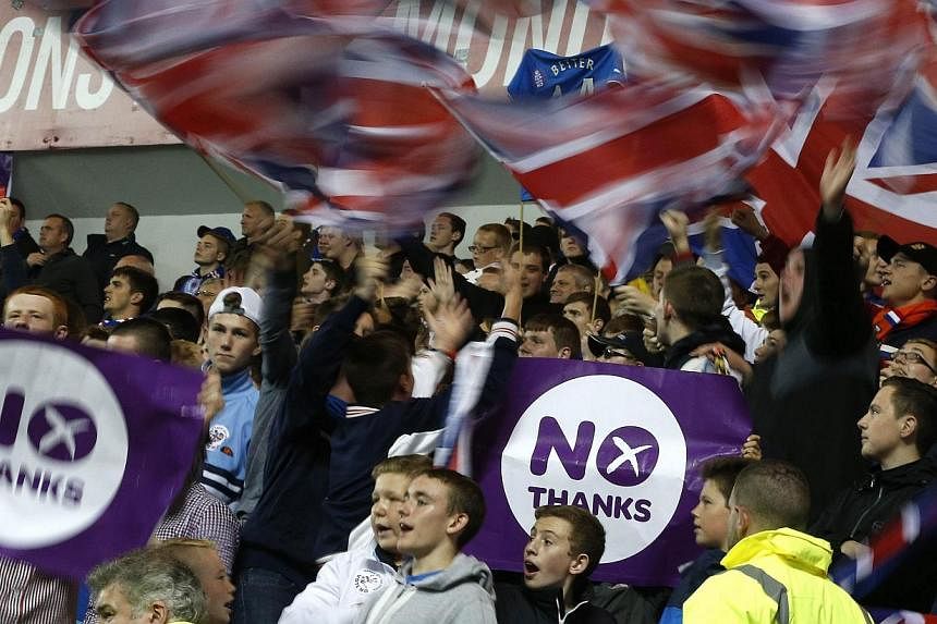 Rangers fans display No Thanks posters during the Rangers versus Inverness Caledonian Thistle soccer match in Glasgow, Scotland, on Sept 16, 2014. -- PHOTO: REUTERS