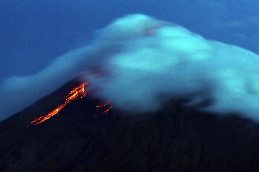 Lava cascaded down the Philippines' most active volcano on Wednesday as authorities rushed to evacuate thousands ahead of a possible deadly eruption. -- PHOTO: AFP