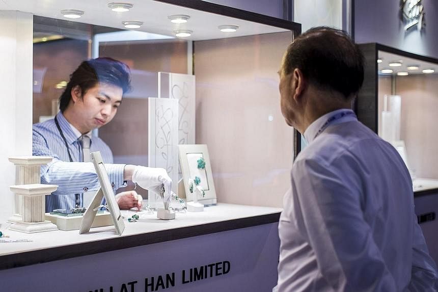 A vendor prepares a jewellery display for the opening of the Hong Kong Jewellery and Gem fair at the convention and exhibition Centre on Sept 17, 2014.&nbsp;Five would-be diamond thieves have been arrested this week for trying to steal gems worth US$