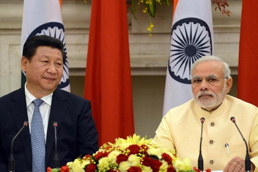 Chinese President Xi Jinping and Indian Prime Minister Narendra Modi look on during the signing of agreements in New Delhi on Sept 18, 2014. India's prime minister expressed concern to China's visiting President Xi Jinping September 18 about "inciden