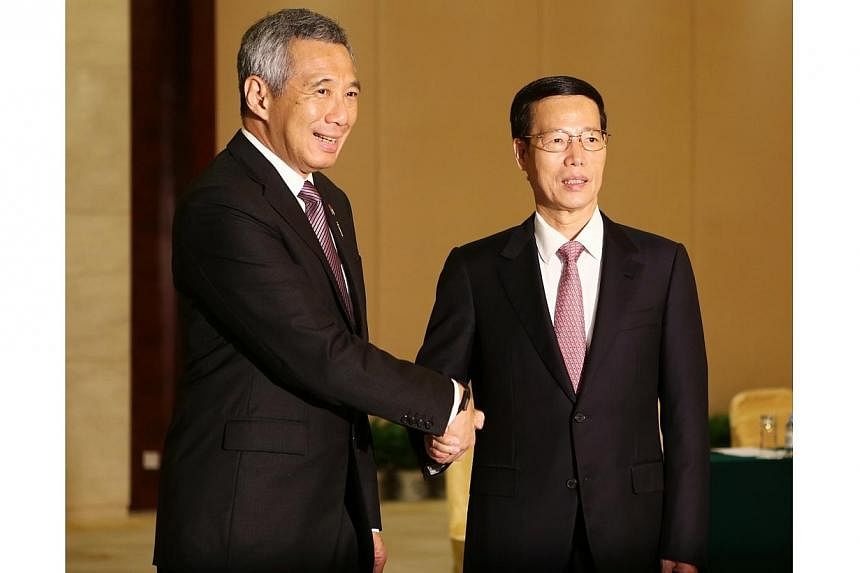 Prime Minister Lee Hsien Loong shake hands with China’s Executive Vice-Premier Zhang Gaoli on 15 Sept 2014.&nbsp;If Singapore embarks on a third government-to-government project with China, it will be in the area of connectivity and modern services