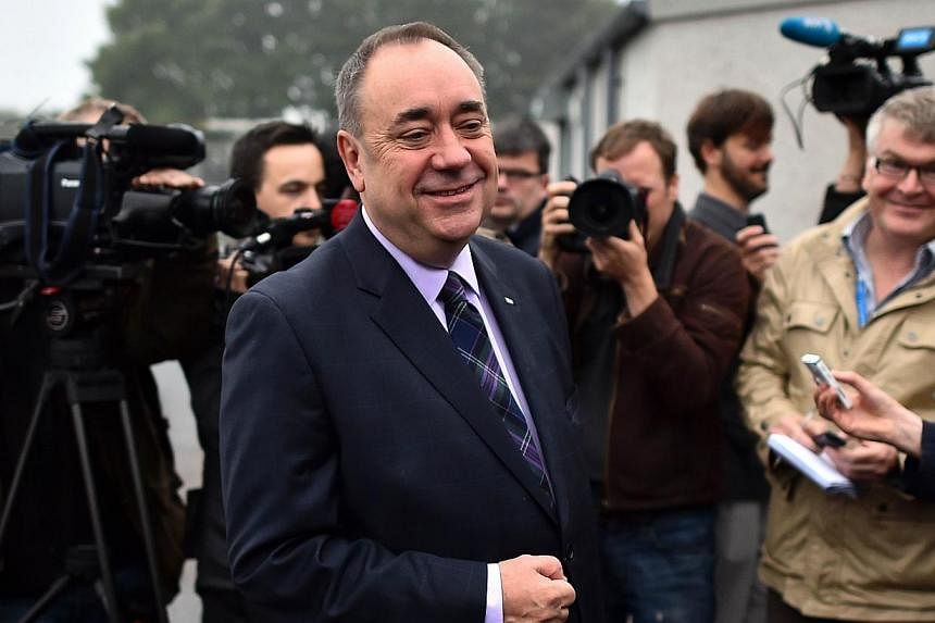 Scotland's First Minister Alex Salmond speaks to the press after casting his vote for Scotland's independence referendum at a polling station in Strichen, Aberdeenshire, on Sept 18, 2014. -- PHOTO: AFP