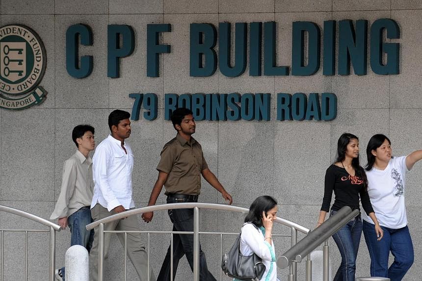 Central Provident Fund (CPF) members will continue to earn at least 4 per cent interest per year on their Special, Medisave and Retirement Account savings for another year until Dec 31, 2015. -- PHOTO: ST FILE