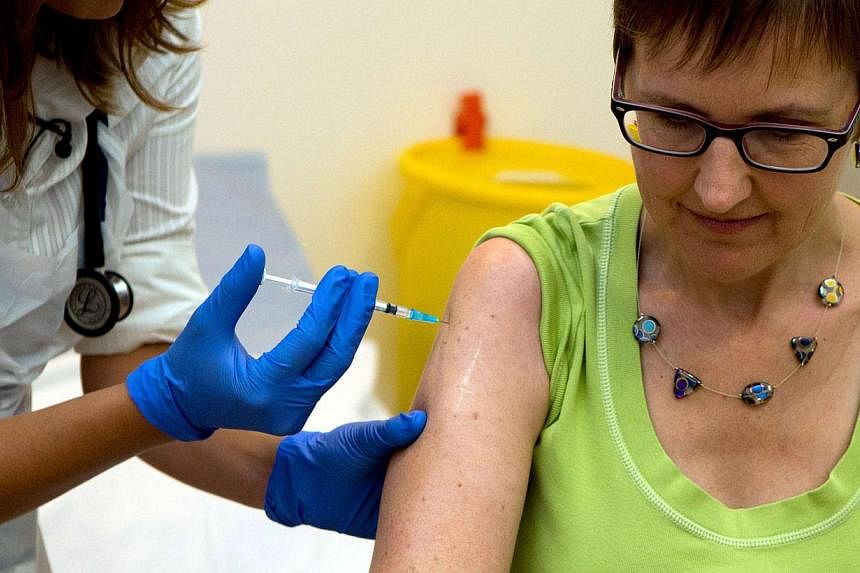 Volunteer Ruth Atkins receives an injection of the Ebola vaccine, at the Oxford Vaccine Group Centre for Clinical Vaccinology and Tropical Medicine (CCVTM) in Oxford, southern England on Sept 17, 2014. -- PHOTO: REUTERS