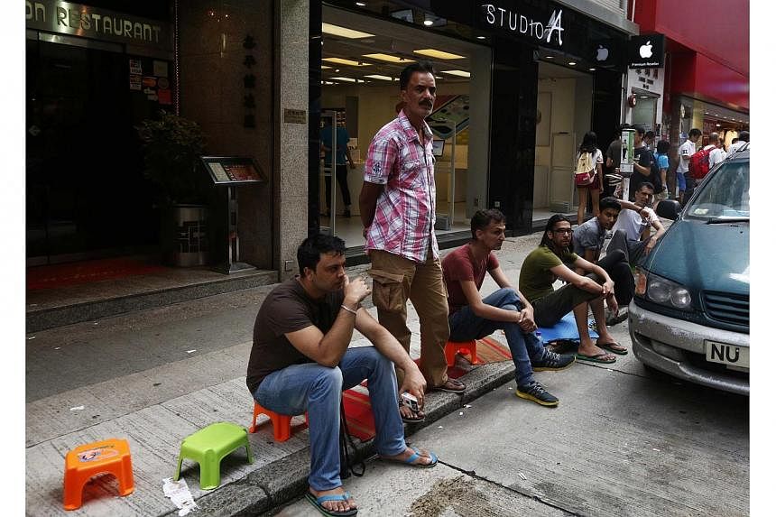 People line up outside an Apple premium reseller store in Hong Kong on Sept 17, 2014, two days ahead of the release of iPhone 6 and 6 Plus. -- PHOTO: REUTERS