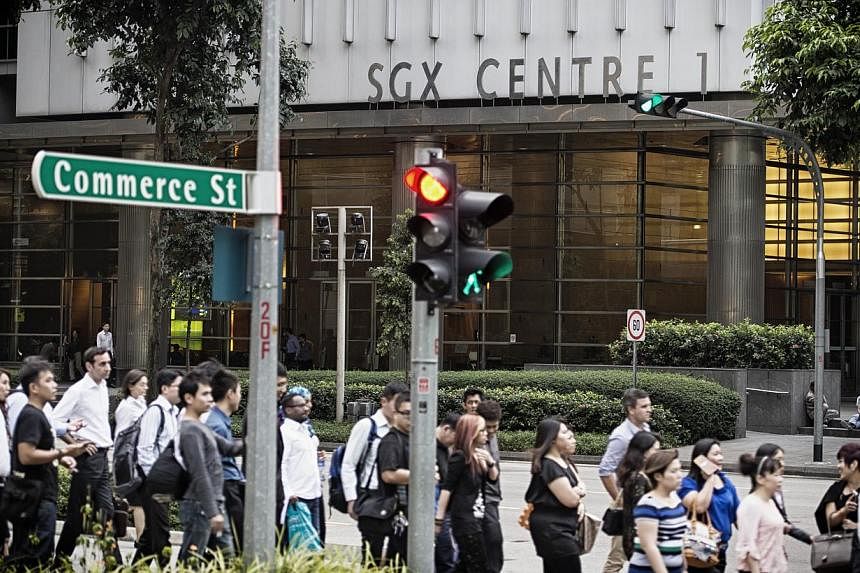 Office workers walk past the SGX Centre, which houses the Singapore Exchange headquarters, in Singapore, on Tuesday, Jan. 21, 2014. -- PHOTO: BLOOMBERG