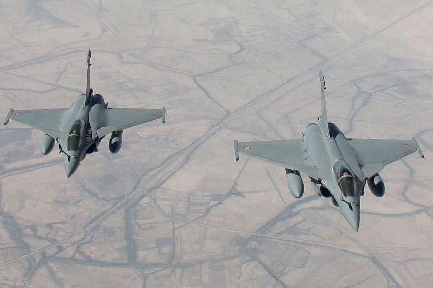 A handout picture taken by EMA and released on Sept 15, 2014, by ECPAD shows two Rafale fighter jets flying on a reconnaissance mission over Iraq after taking off from the Al-Dhafra base in the United Arab Emirates.&nbsp;France said on Friday its jet