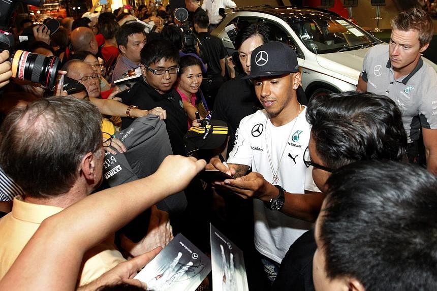 Mercedes driver Lewis Hamilton of Britain meeting fans at Paragon shopping centre yesterday before heading to the Marina Bay Street Circuit. More than 200,000 spectators are expected at the circuit park this weekend.