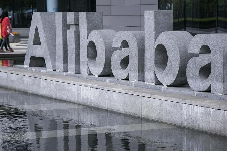People walk by the headquarters of Alibaba in Hangzhou, Zhejiang province, in this April 23, 2014 file photo. Alibaba Group Holding priced its initial public offering at US$68 a share, the top end of the expected range, raising US$21.8 billion (S$27.
