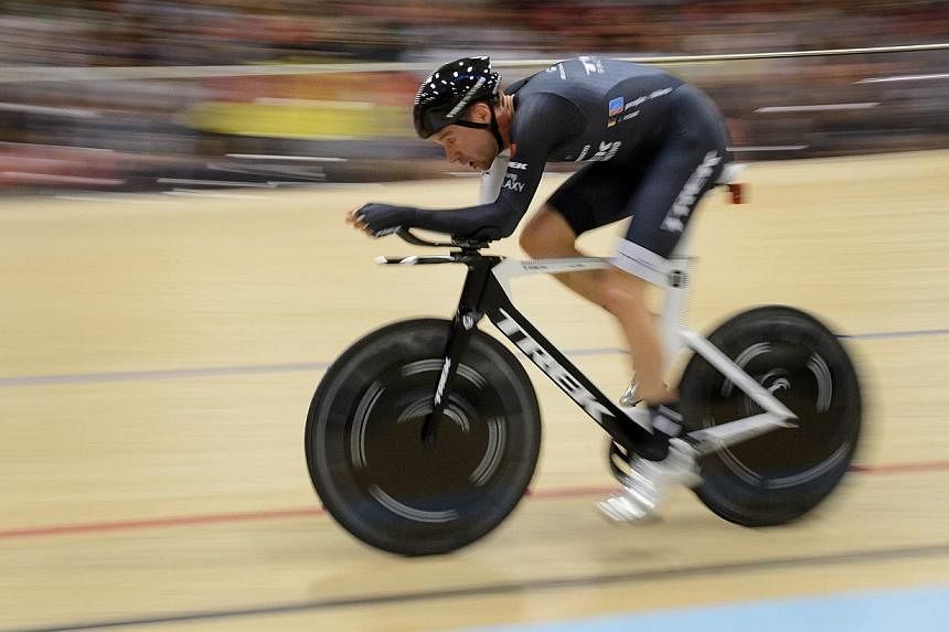 German cyclist Jens Voigt, recently retired, rides during his world hour record attempt on September 18, 2014 at the Velodrome Suisse in Grenchen. -- PHOTO: AFP&nbsp;
