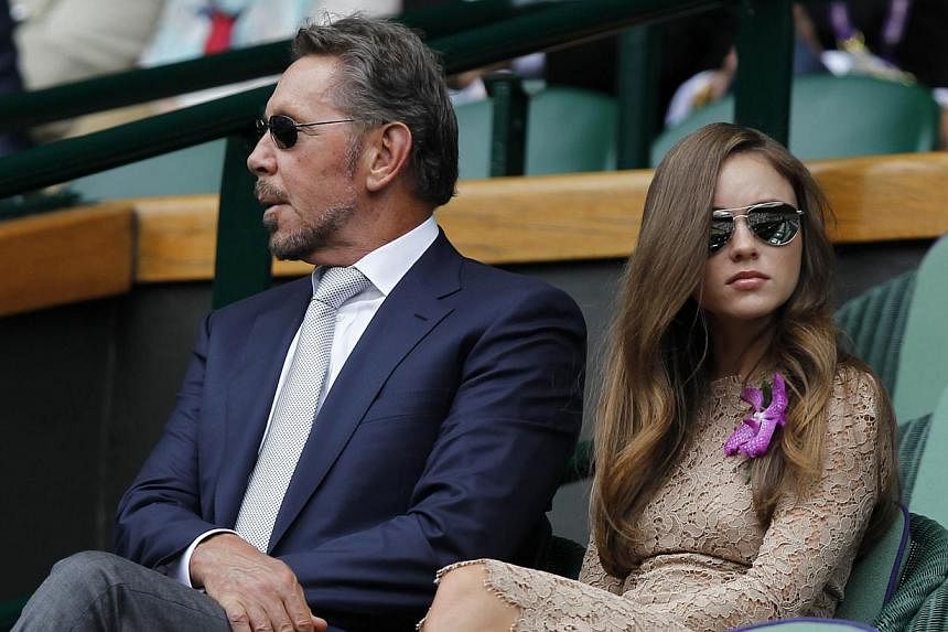Oracle co-founder Larry Ellison with Nikita Kahn in the Royal Box on the Centre Court at Wimbledon on July 6, 2014. Ellison on Thursday stepped down as chief executive of Oracle, the successful technology company he co-founded in 1977. -- PHOTO: AFP