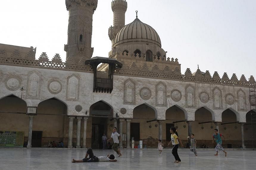 Children play in the yard of Al-Azhar Mosque in Cairo while their families pray inside the mosque during the holy month of Ramadan on July 1, 2014. Saudi Arabia has agreed to fund the restoration of the mosque in recognition of its role as a "beacon 