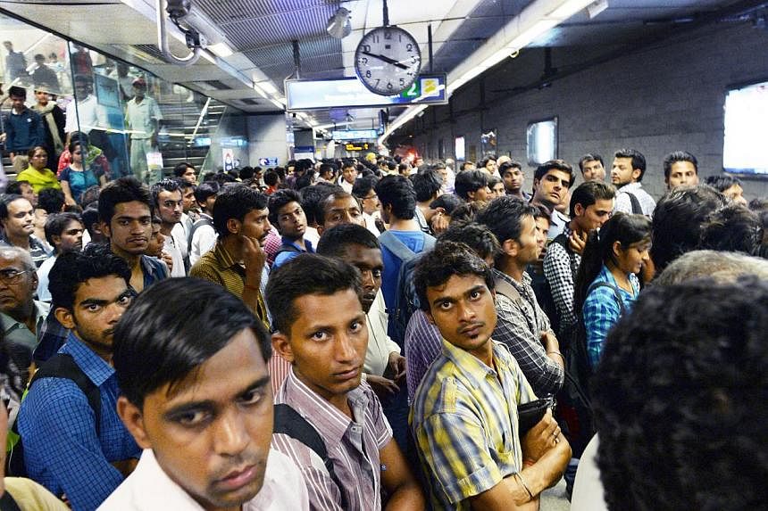 Commuters waiting on a station platform for the metro train in New Delhi on the occasion of World Population Day on&nbsp;July 11, 2014.&nbsp;The world population may grow larger than previously estimated, reaching 11 billion people by century's end, 