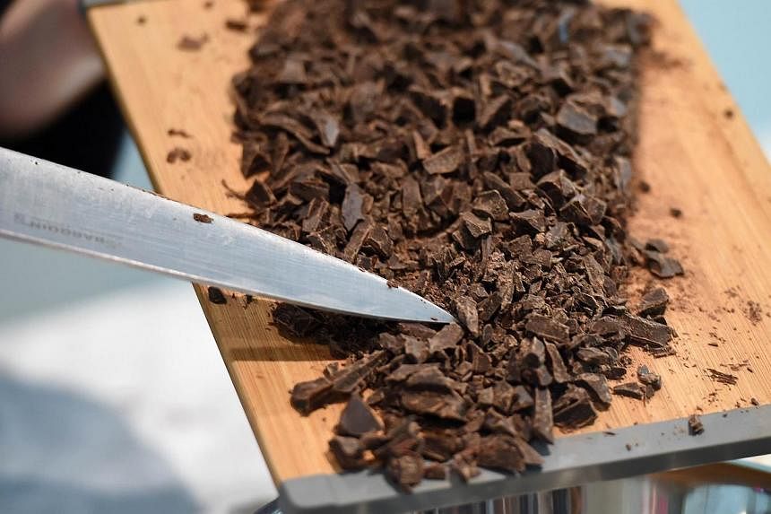 A chocolate-maker makes preparations during a preview of the Belgium Chocolate Village, a museum dedicated to Belgium's chocolate-making history, in Brussels on Sept 19, 2014. -- PHOTO: AFP