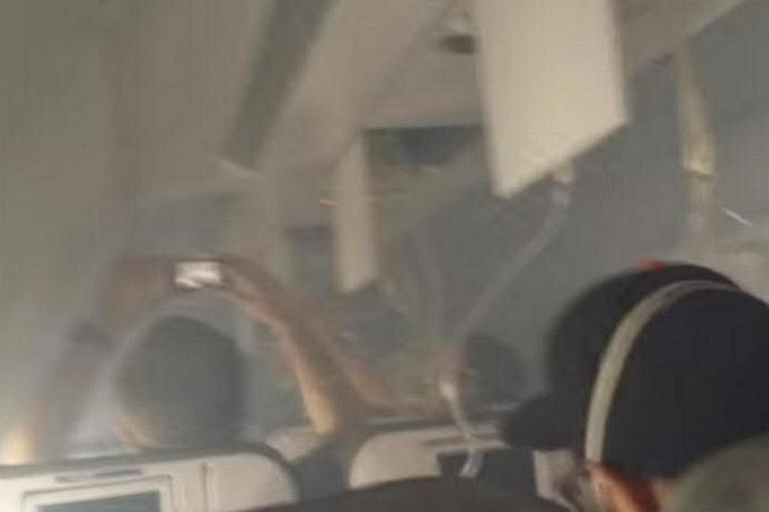 Passengers wear oxygen masks in a smoke filled cabin of a JetBlue airliner. -- SCREENGRAB: YOUTUBE