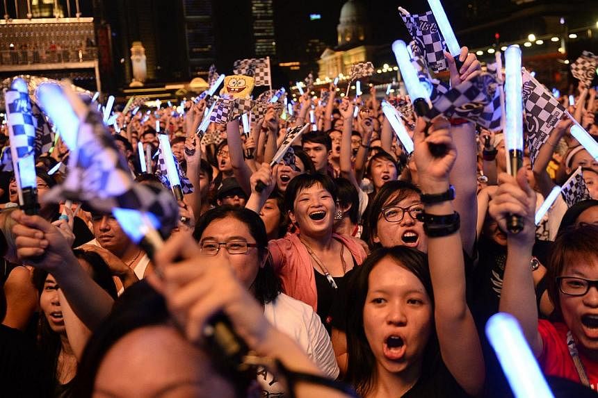 Concert attendees sing and wave their lightsticks during Taiwanese band Mayday's performance at the Padang Stage at the 2014 Formula One Singapore Airlines Singapore Grand Prix on Sept 19, 2014. -- ST PHOTO: MARK CHEONG