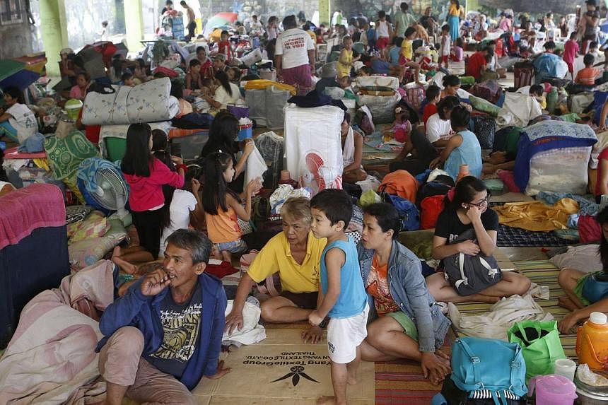 Residents take shelter at an evacuation centre for flood victims a day after tropical storm Fung-Wong inundated the Philippine capital Manila on Sept 20, 2014. -- PHOTO: REUTERS