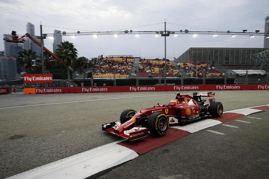 Ferrari Formula One driver Kimi Raikkonen of Finland drives during the third practice session of the Singapore Formula One Grand Prix at the Marina Bay street circuit in Singapore on Sept 20, 2014. -- PHOTO: REUTERS