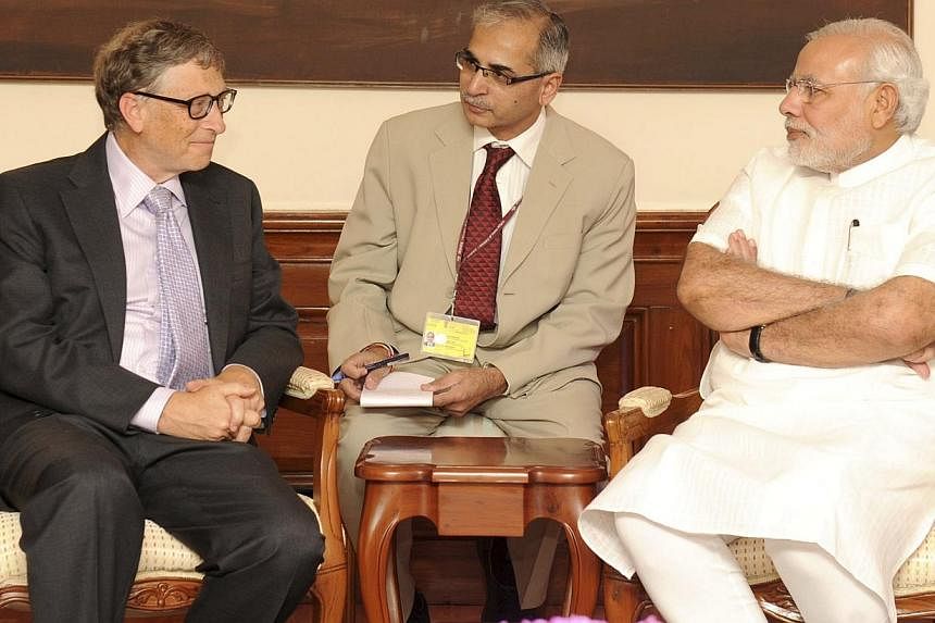 Microsoft's technology advisor Bill Gates (left) speaks with India's Prime Minister Narendra Modi (right) during their meeting in New Delhi on Sept 19, 2014. -- PHOTO: REUTERS