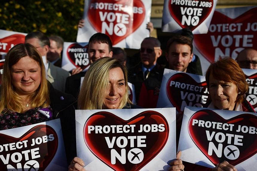 Pro-Union 'No' supporters pose for a picture during a rally in Edinburgh, Scotland, on September 16, 2014, ahead of the referendum on Scotland's independence.&nbsp;Scots were driven to reject independence in a historic referendum more out of fears ov