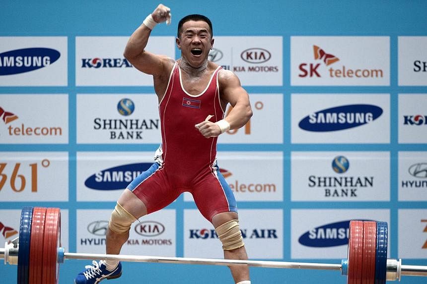 Gold medalist Om Yun Chol of North Korea celebrates after winning the men's 56kg weightlifting event during the 2014 Asian Games in Incheon on Sept 20, 2014. -- PHOTO: AFP