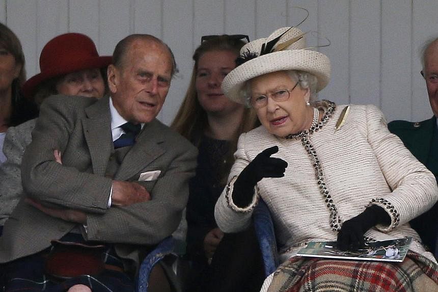 Britain's Queen Elizabeth (right) and Prince Philip (left) talk as they watch the caber being tossed at the annual Braemar Highland Gathering in Braemar, Scotland on September 6, 2014. The Queen&nbsp;urged her subjects in the United Kingdom on Friday