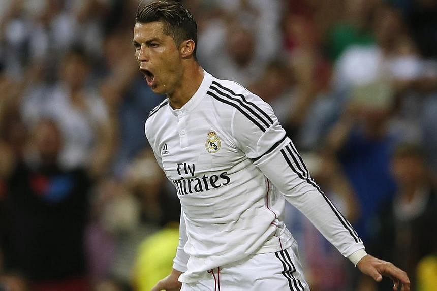Real Madrid's Cristiano Ronaldo celebrates his goal during their Spanish first division soccer match against Atletico Madrid at Santiago Bernabeu stadium in Madrid September 13, 2014. Manchester United manager Louis van Gaal said Friday he would like