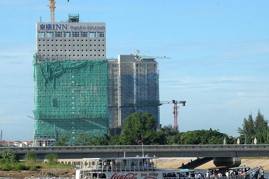 New buildings being constructed in Phnom Penh in August 2014. -- PHOTO: AFP
