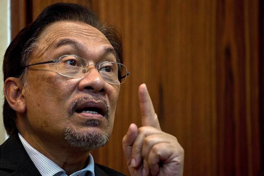 This file photo taken on April 9, 2014, shows Malaysian opposition leader Anwar Ibrahim speaking during an interview with AFP at his party office in Kuala Lumpur.&nbsp;Anwar was questioned last Friday over comments he made in a 2011 political speech,
