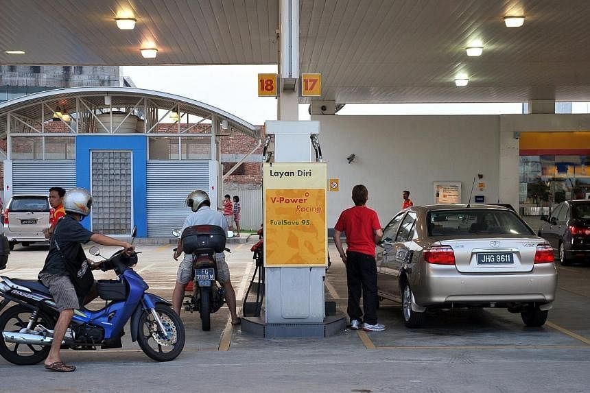 A Shell petrol station in Johor Bahru on 12 June 2011.&nbsp;Malaysia will raise prices of petrol and diesel by 20 sen (8 Singapore cents) from midnight on Wednesday. -- PHOTO: ST FILE