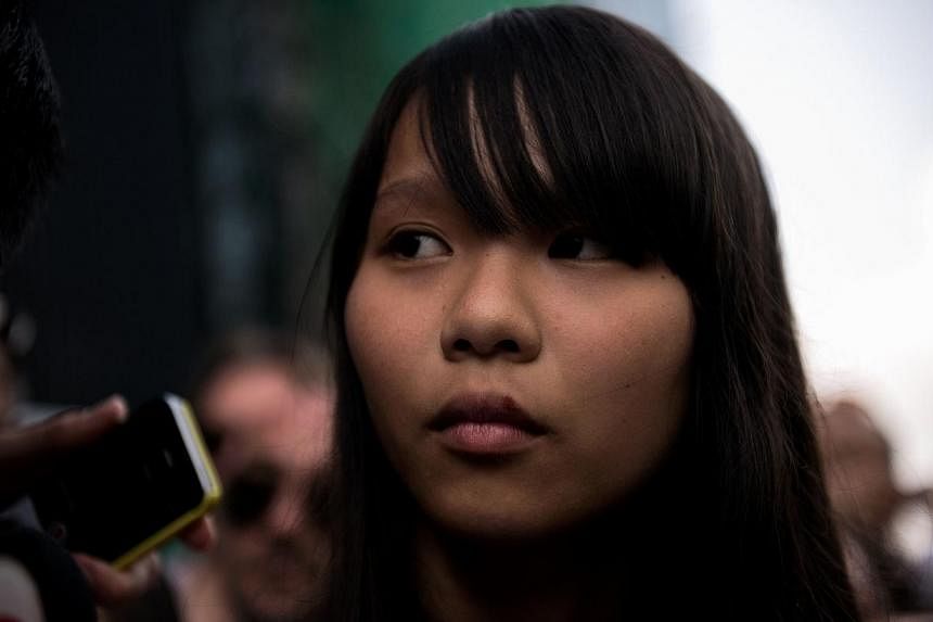 Student Agnes Chow listens to a question at a press conference on the next move for the pro-democracy protests that have gripped Hong Kong on Oct 1, 2014. -- PHOTO: AFP