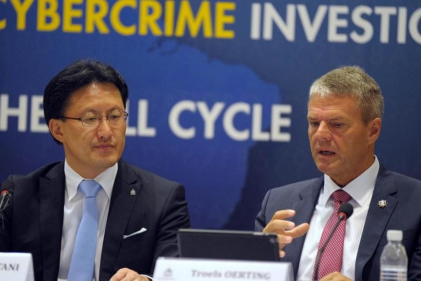 Assistant Director Head of EC3 Europol Troels Oerting (right) speaks next to Executive Director of Interpol Global Complex for Innovation (ICGI) Noboru Nakatani during the Interpol-Europol cybercrime conference at the Cantonment police headquaters in