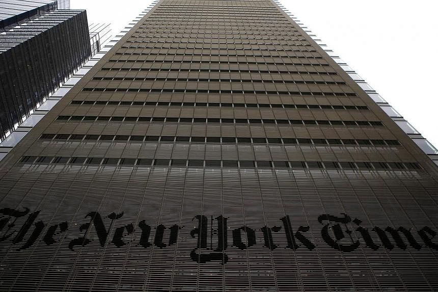 The New York Times building is seen in New York, in this file photo taken on Feb 7, 2013. The prestigious daily said Wednesday it plans to cut 100 newsroom jobs in the latest move to adapt to industry upheaval. -- PHOTO: REUTERS