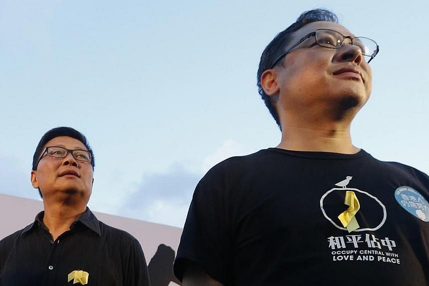 Academics Benny Tai (right) and Chan Kin Man, founders of the Occupy Central civil disobedience movement, attend a pro-democracy rally in Hong Kong on Aug 31, 2014. Chan struggled to contain his emotions on Wednesday as he warned that protests would 