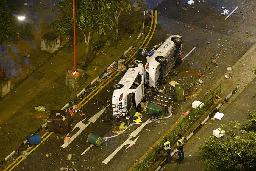 The overturned police cars in the aftermath of the Little India riot on Dec 9, 2013. -- ST FILE PHOTO: ALPHONSUS CHERN&nbsp;
