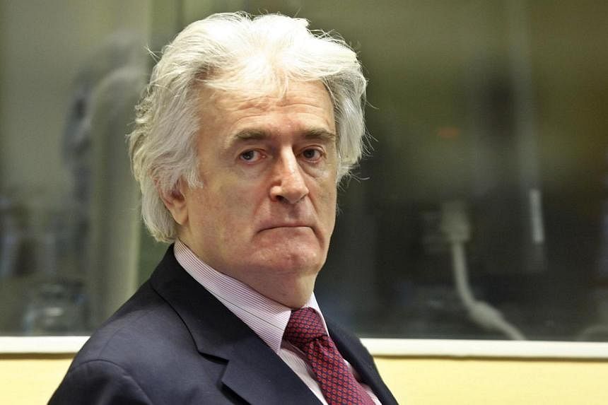 A file photo on Nov 3, 2009 shows former Bosnian Serb leader Radovan Karadzic in the courtroom of the ICTY War Crimes tribunal in the Hague.&nbsp;Dr Karadzic "did not know" of the 1995 massacre of thousands of Muslims at Srebrenica, his lawyer said o