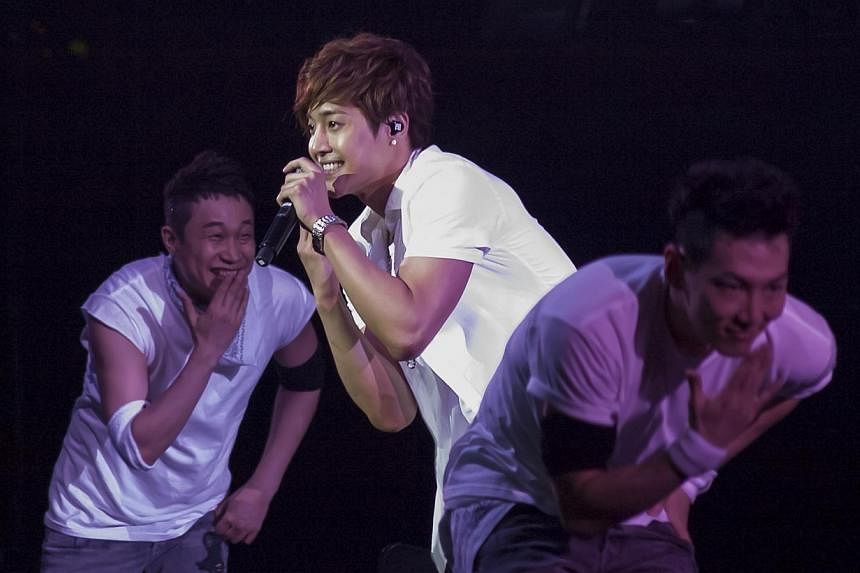 Korean pop star Kim Hyun Joong performing at the Singapore Indoor Stadium on May 4, 2012.&nbsp;All charges except one have been dropped against Kim, who is accused of assaulting his ex-girlfriend, the local police said on Monday. -- PHOTO: ST FILE