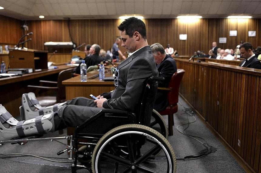 Carl Pistorius, brother of Olympic and Paralympic track star Oscar Pistorius, sits in a wheel chair during Oscar Pistorius' judgment at the North Gauteng High Court in Pretoria, Sept 11, 2014.&nbsp;Police suspected Carl Pistorius of wiping data from 