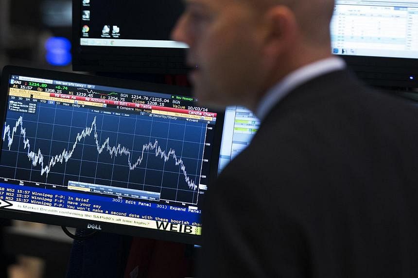 A trader works on the floor of the New York Stock Exchange on Oct 1, 2014. -- PHOTO: REUTERS