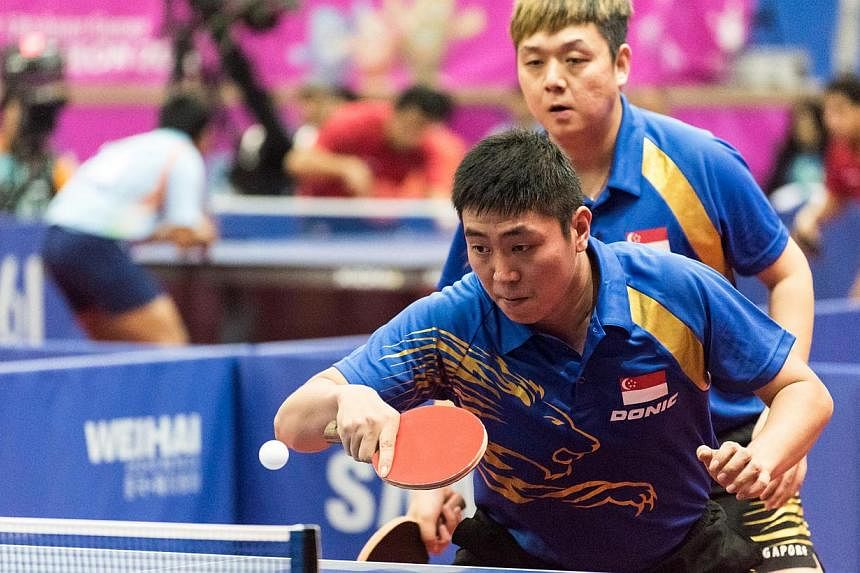 Singapore's Gao Ning and Li Hu (behind) in action at the Table Tennis Men's Doubles Round 2.&nbsp;SINGAPORE'S table tennis men's doubles pair of Gao Ning and Li Hu assured themselves of at least winning a medal at the Incheon Asian Games on Thursday.