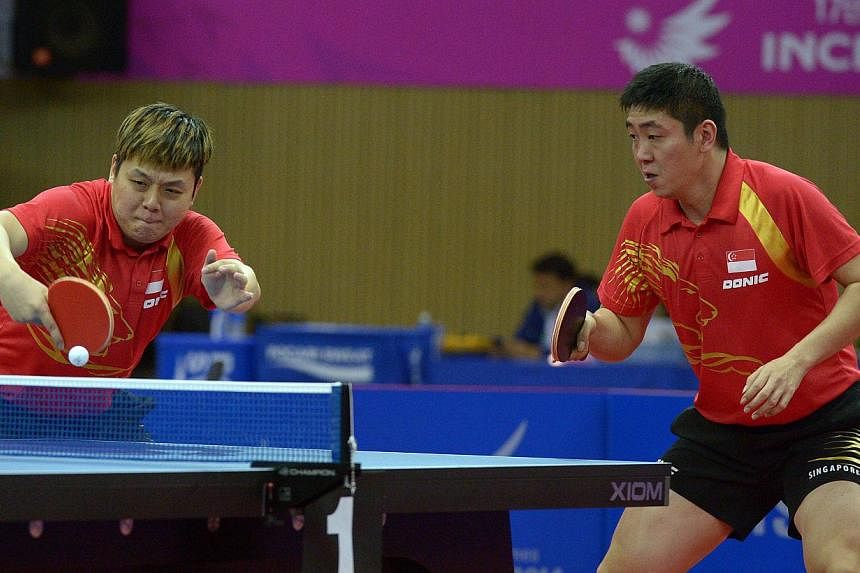 Singapore men's paddlers Gao Ning and Li Hu clinched the 12th bronze medal for Singapore at the Incheon Asian Games on Friday, despite losing their men's doubles semi-final match against China's Xu Xin and Fan Zhendong. -- ST PHOTO: DESMOND WEE&nbsp;