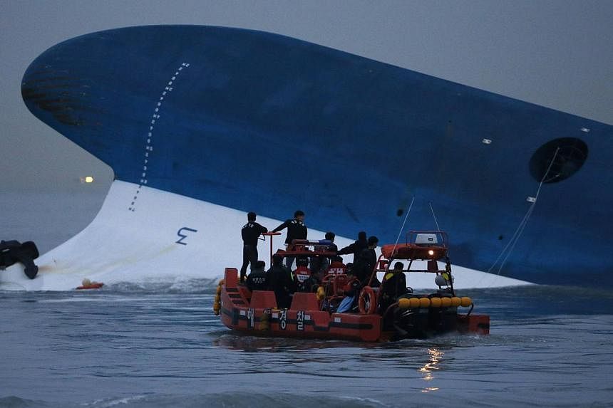 Maritime police search for missing passengers in front of the South Korean Sewol ferry which sank at sea, off Jindo, on April 16, 2014.&nbsp;Dozens of South Korean filmmakers and critics rallied behind a controversial film on the Sewol ferry disaster