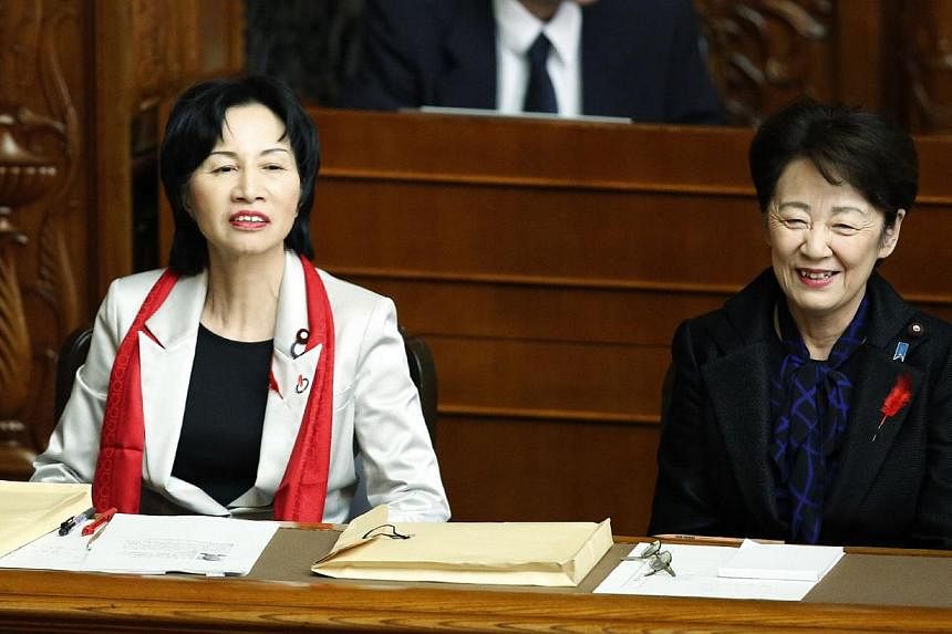 Japan's Justice Minister Midori Matsushima (left) attending the Upper House plenary session at the parliament in Tokyo on Oct 1, 2014, with the red scarf, which caused a dress code row. -- PHOTO: AFP