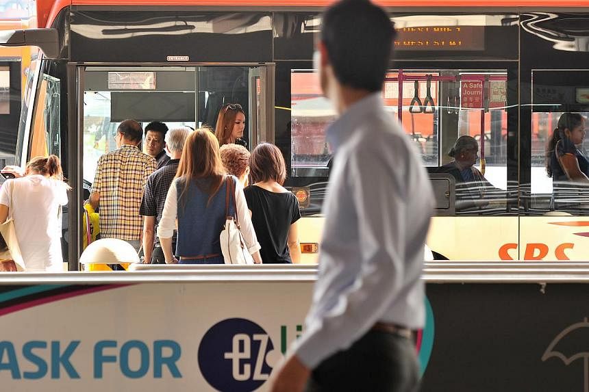 Commuters boarding a bus at Jurong East bus interchange. The Land Transport Authority (LTA) has put up the first package of bus routes for tender. -- ST PHOTO: LIM YAOHUI